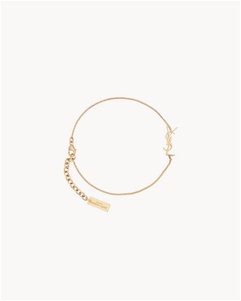 ysl charm bracelet gold brass|yves saint laurent gold earrings.